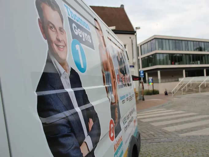 Poster on a parked van of then Councilor Thomas Geyns alongside Kristina Eyskens ahead of October 2024 elections.